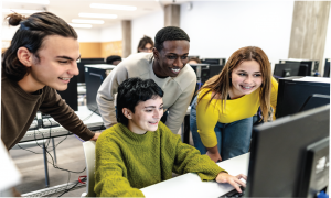 4 High School students in a computer lab.