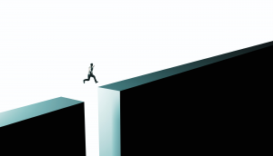 Business person leaping over gap.